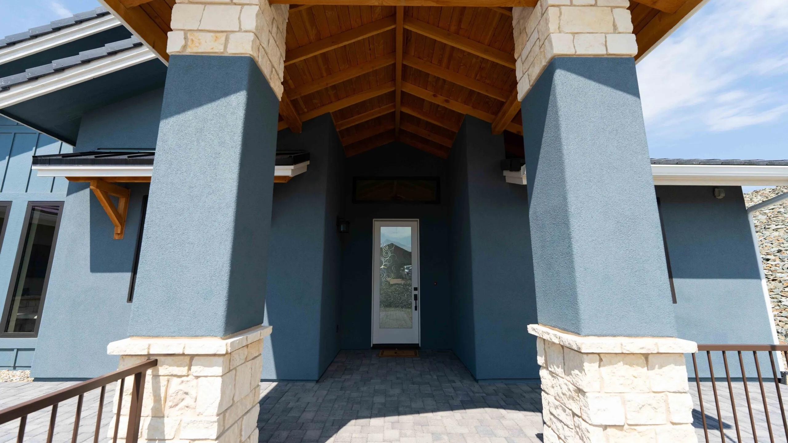 Custom stucco entry with blue stone columns