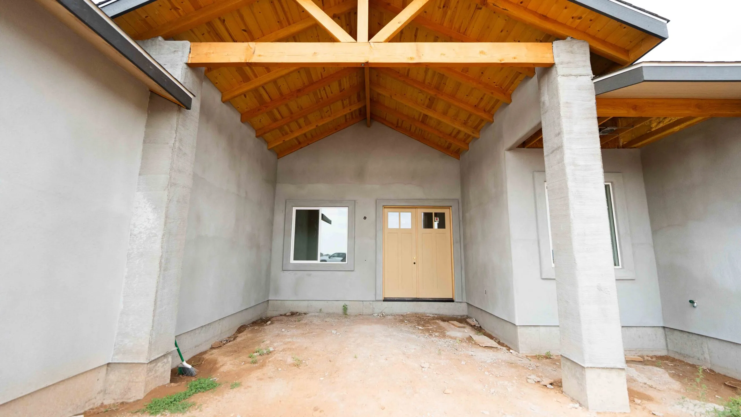Stucco entry porch with wood beam ceiling