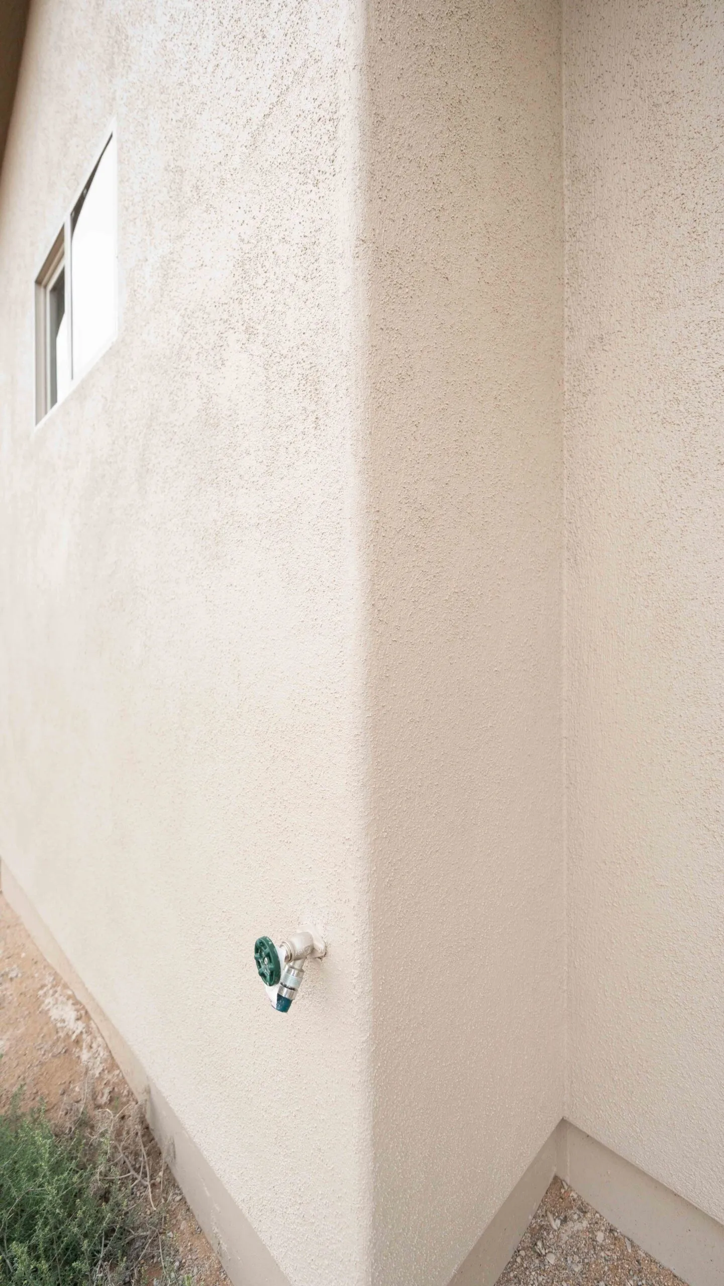 Stucco wall corner with sand texture